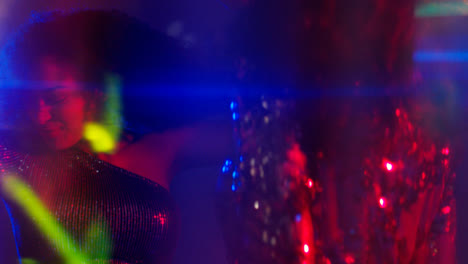 Close-Up-Of-Two-Women-In-Nightclub-Bar-Or-Disco-Dancing-With-Sparkling-Lights-8